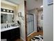 Bathroom featuring a wooden post divider, new shower, and dark cabinets at 142 Kylee Ct, Villa Rica, GA 30180