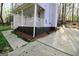 Charming home exterior featuring a screened-in porch and well-maintained landscaping at 142 Kylee Ct, Villa Rica, GA 30180