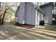 Exterior view of gray home featuring clean siding, manicured mulch and concrete driveway at 142 Kylee Ct, Villa Rica, GA 30180