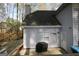 Home exterior with gray siding, a back patio and trimmed landscaping at 142 Kylee Ct, Villa Rica, GA 30180