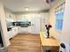Bright kitchen with white cabinets, black countertops, and wood-look tile flooring at 142 Kylee Ct, Villa Rica, GA 30180