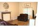 Inviting living room featuring a brick fireplace, wood-look tile floors, and a large window with natural light at 142 Kylee Ct, Villa Rica, GA 30180