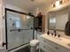 Well-lit bathroom featuring a glass-door shower, toilet, and a vanity with a sink and wooden cabinet at 324 Bells Ferry Ne Rd, White, GA 30184
