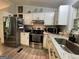 Bright kitchen features white cabinets, granite countertops, and stainless steel appliances at 324 Bells Ferry Ne Rd, White, GA 30184