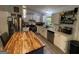 This kitchen boasts white cabinets, stainless steel appliances and a butcher block island at 324 Bells Ferry Ne Rd, White, GA 30184