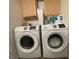 Laundry room featuring a washing machine, dryer, and overhead cabinet storage at 324 Bells Ferry Ne Rd, White, GA 30184