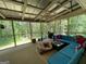 Relaxing screened porch with comfortable seating, perfect for enjoying the outdoors at 324 Bells Ferry Ne Rd, White, GA 30184