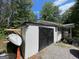 Storage shed with black double doors and gravel driveway at 324 Bells Ferry Ne Rd, White, GA 30184