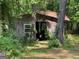 Rustic shed nestled among trees, offering farm fresh eggs for sale, with a window and open entryway at 324 Bells Ferry Ne Rd, White, GA 30184