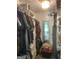 Organized walk-in closet with clothing racks and storage shelves with mirror at end at 324 Bells Ferry Ne Rd, White, GA 30184