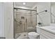 Bright bathroom with tiled walk-in shower, toilet, and white cabinets at 502 Pine Cir, Peachtree City, GA 30269