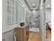 Bright bathroom featuring glass enclosed shower, wooden floors, and window with shutters at 502 Pine Cir, Peachtree City, GA 30269