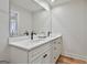 Modern bathroom featuring dual sinks, white countertops and cabinets, and black faucets at 502 Pine Cir, Peachtree City, GA 30269