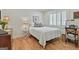 Cozy bedroom with wood floors, a lamp, and windows with white shutters at 502 Pine Cir, Peachtree City, GA 30269