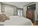 Bright bedroom featuring hardwood floors, white walls, closet, and French doors at 502 Pine Cir, Peachtree City, GA 30269
