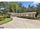 Spacious home with a long driveway, an attached garage, and manicured landscaping at 502 Pine Cir, Peachtree City, GA 30269