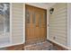 Close-up of a beautiful wood double front door with decorative glass panels and brick steps at 502 Pine Cir, Peachtree City, GA 30269