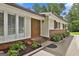 Inviting home entrance featuring a stylish wood double door, brick accents, and well-maintained landscaping at 502 Pine Cir, Peachtree City, GA 30269
