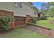 View of the house exterior with a single garage door and a green lawn at 502 Pine Cir, Peachtree City, GA 30269