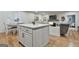 The kitchen island flows into the dining area and living room of this home at 502 Pine Cir, Peachtree City, GA 30269
