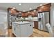 Modern kitchen features stainless steel appliances, wood cabinets, and a white island with a stone countertop at 502 Pine Cir, Peachtree City, GA 30269