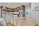 Kitchen flows to the dining area and features wood cabinets and stainless appliances at 502 Pine Cir, Peachtree City, GA 30269