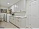 Laundry room with white cabinets, a countertop, and a washer and dryer at 502 Pine Cir, Peachtree City, GA 30269