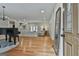 Bright living room features hardwood floors and a piano near the entryway at 502 Pine Cir, Peachtree City, GA 30269
