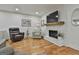 Living room features hardwood floors and fireplace with white painted brick at 502 Pine Cir, Peachtree City, GA 30269