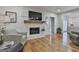 Living room features hardwood floors and fireplace with a mounted television at 502 Pine Cir, Peachtree City, GA 30269
