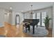 Bright living room with hardwood floors, a piano, and glass paneled doors at 502 Pine Cir, Peachtree City, GA 30269