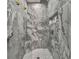 Stunning marble-walled walk-in shower featuring a shower head and a built-in bench at 502 Pine Cir, Peachtree City, GA 30269