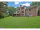 Expansive backyard with mature trees surrounding the home and a fenced area for added security at 2795 Hawthorne Dr, Atlanta, GA 30345