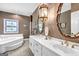 Elegant bathroom featuring double sinks, white cabinets, and a soaking tub under a stained-glass window at 2795 Hawthorne Dr, Atlanta, GA 30345