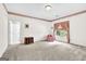 Spacious room with neutral carpet, a window with pink curtains, and vintage furniture at 2795 Hawthorne Dr, Atlanta, GA 30345