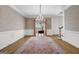 Elegant dining room adorned with a crystal chandelier, wallpaper, and large windows for ample natural light at 2795 Hawthorne Dr, Atlanta, GA 30345