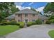 Charming brick home with manicured landscaping, complemented by green shutters and a welcoming entranceway at 2795 Hawthorne Dr, Atlanta, GA 30345