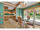 Eat-in kitchen featuring wood cabinets, a chandelier, a glass table, and a deck entrance at 2795 Hawthorne Dr, Atlanta, GA 30345