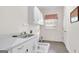 Bright laundry room with white cabinets, a sink, a countertop, and tiled flooring at 2795 Hawthorne Dr, Atlanta, GA 30345