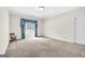 Spacious living room with neutral carpet, a window with blue curtains, and a rocking chair at 2795 Hawthorne Dr, Atlanta, GA 30345