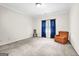 Carpeted living room with a window dressed in blue, comfortable seating, and natural light at 2795 Hawthorne Dr, Atlanta, GA 30345