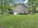Brick home featuring attached garage and well maintained lawn at 120 Rolling Brook Trl, Fayetteville, GA 30215