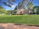 Backyard with large lawn, wooden deck, and screened-in porch at 120 Rolling Brook Trl, Fayetteville, GA 30215