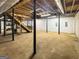 Unfinished basement with concrete floors and exposed ceiling beams ready for customization at 120 Rolling Brook Trl, Fayetteville, GA 30215