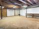 Open unfinished basement with a garage door and workbench, ideal for various projects at 120 Rolling Brook Trl, Fayetteville, GA 30215