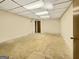 Empty basement room with a dropped ceiling ready to be updated and converted at 120 Rolling Brook Trl, Fayetteville, GA 30215