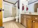 Cozy bathroom features a shower-tub combination and a wooden vanity at 120 Rolling Brook Trl, Fayetteville, GA 30215