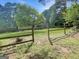 View of the home with a fenced backyard and lush green lawn at 120 Rolling Brook Trl, Fayetteville, GA 30215