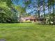 Charming brick home with lush lawn and mature trees offers great curb appeal at 120 Rolling Brook Trl, Fayetteville, GA 30215