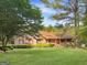 Beautiful brick home with red shutters and a lush green lawn at 120 Rolling Brook Trl, Fayetteville, GA 30215